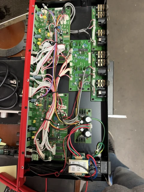 Open audio rack unit showing circuit boards, ribbon cables, and internal power wiring