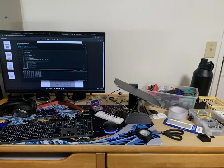 My solar tracker, breadboard electronics, and control code at the workbench